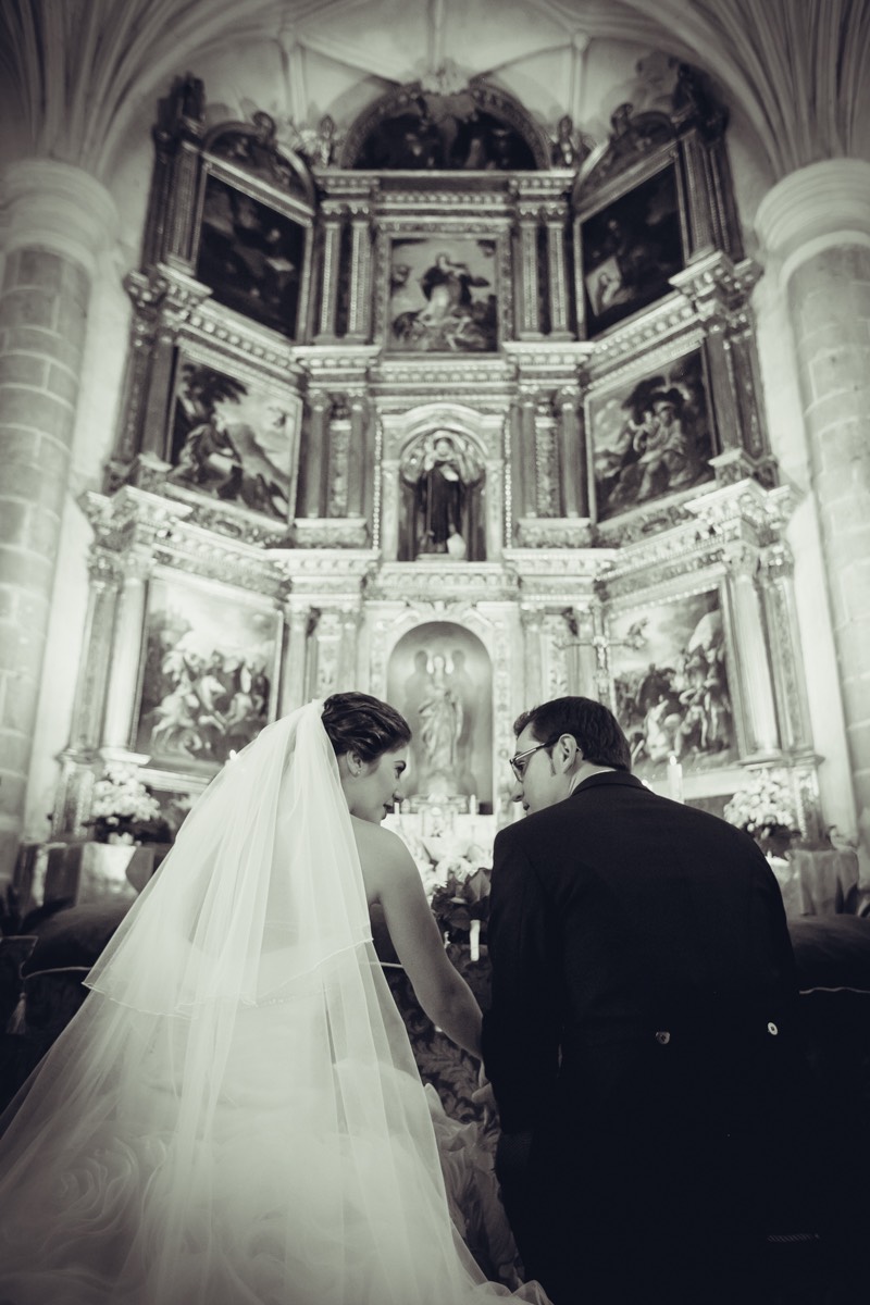 Emocionante foto de una novia enseñando su vestido a sus amigas al terminar de vestirse. Todas están sonrientes y emicionadas
